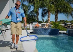 Pool Technician Cleaning Pool